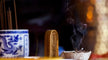 Taoist priest performing incense visualization ritual before a sacred altar