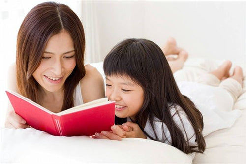 Aunt and niece bonding while reading a book together, exploring dreams and meanings.