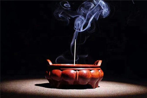 Incense burner glowing on a Taoist altar in a dream