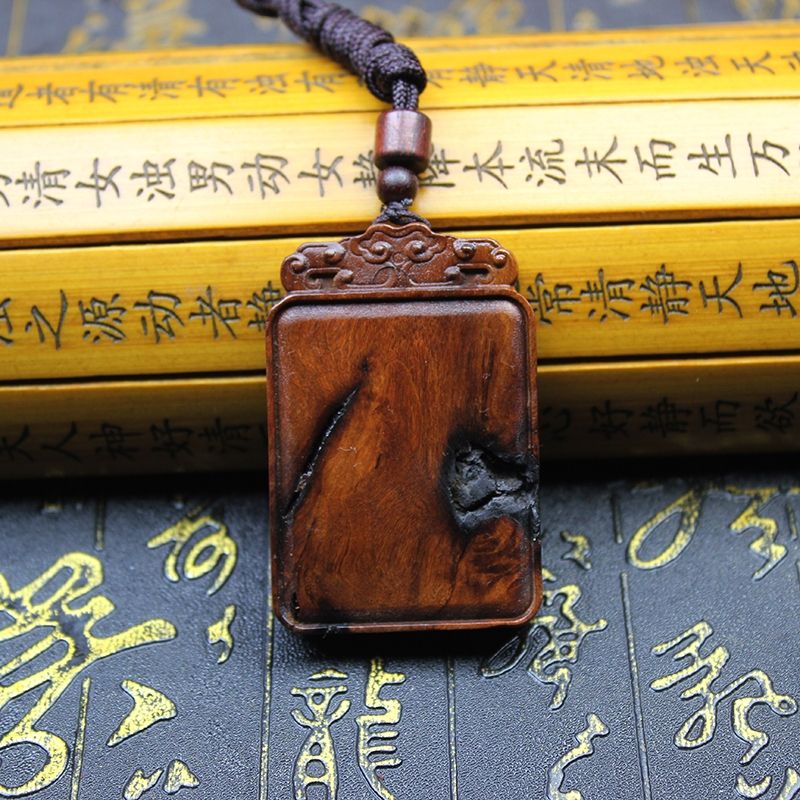 Daoist Thunderstruck Jujube Wood Peace Talisman Plaque on a decorative background of golden inscriptions.